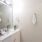 bathroom sink with mirror and ample lighting